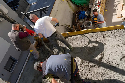 Workers pouring concrete during a concrete project to determine concrete price.