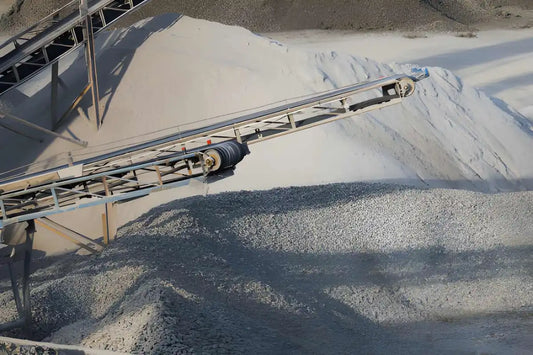 Loader moving crushed concrete inside a covered storage facility.