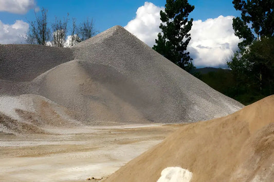Piles of sand fill material at a construction aggregate site.